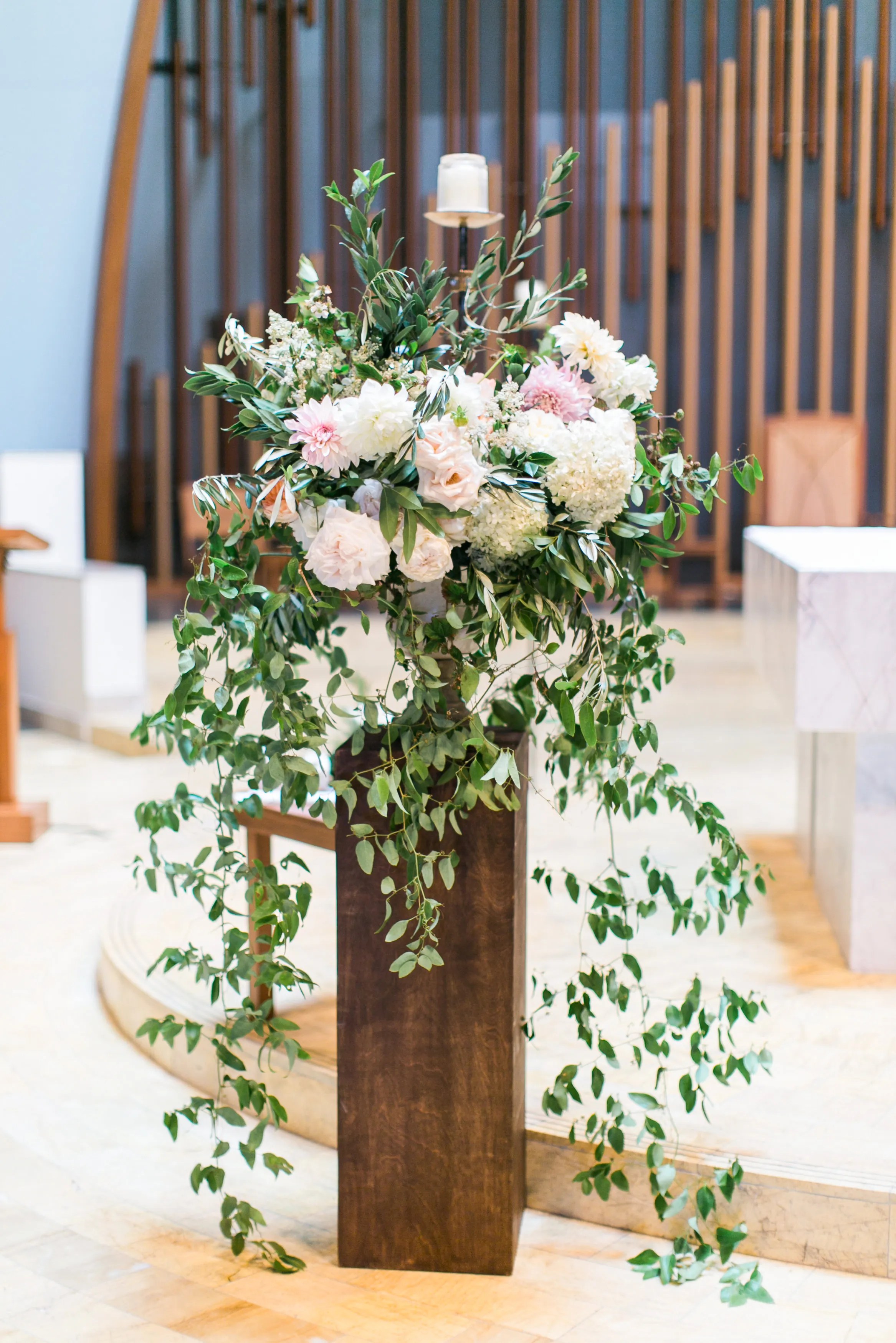 Cascading, romantic ceremony floral arrangements