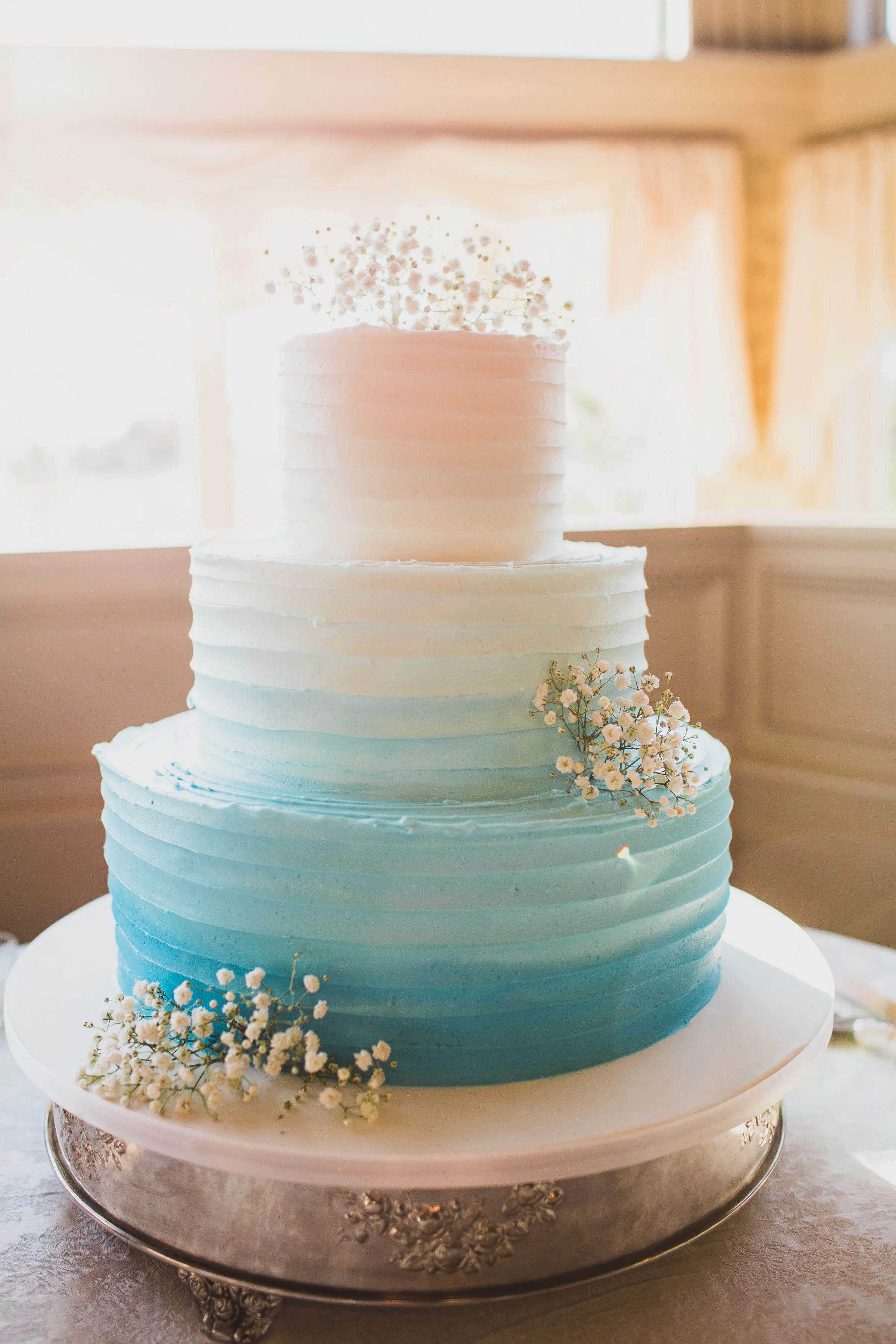 If you feel obligated to invite a bunch of people to your wedding while secretly hoping the majority of them send their regrets, the destination wedding is the way to go. Ombre Blue and White Tiered Wedding Cake