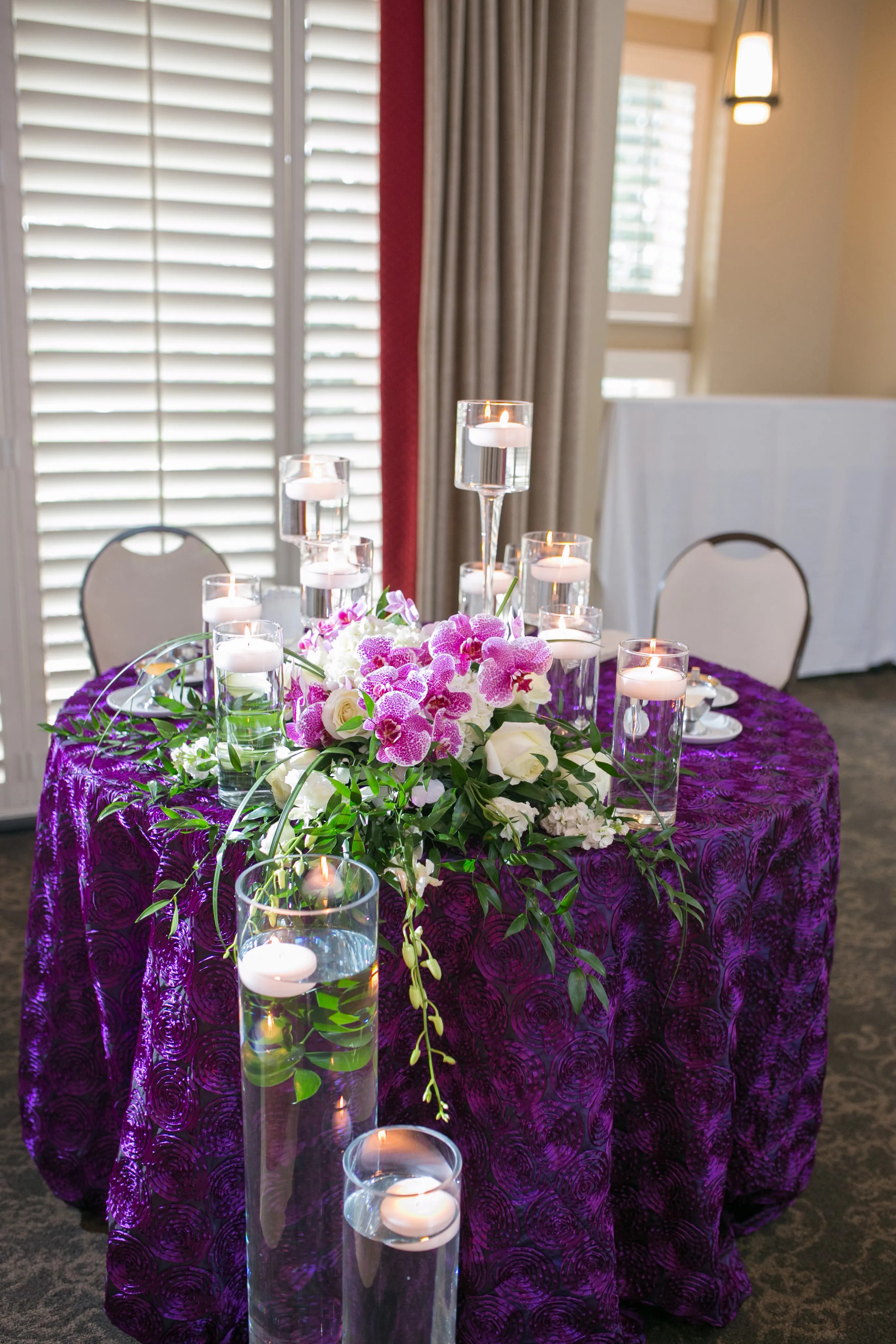 Saying yes to all these dresses. Purple Sweetheart Table with Orchids and Candles