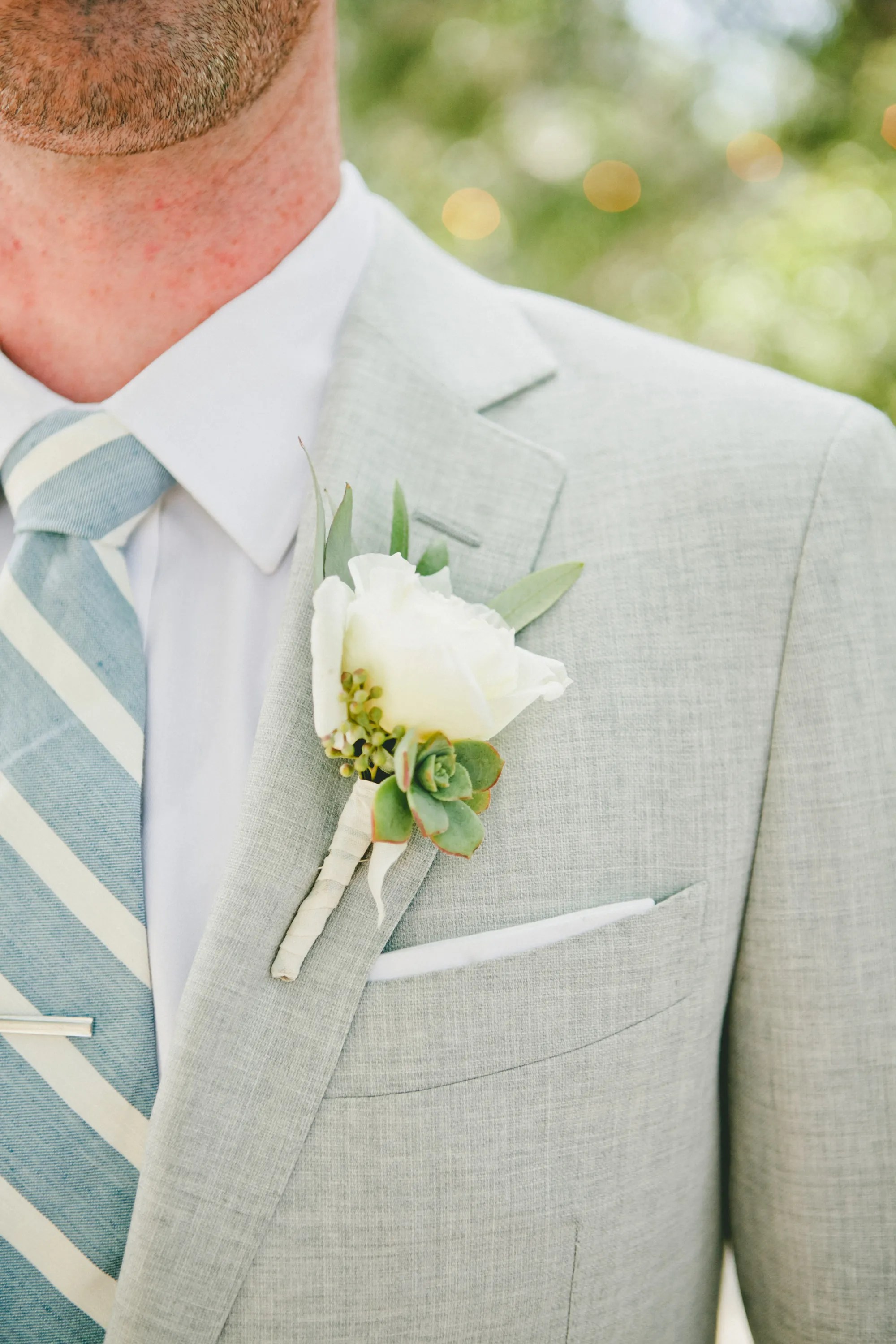 Succulents are the perfect plant to create a unique boutonniere for a wedding or prom. White Rose And Succulent Boutonniere