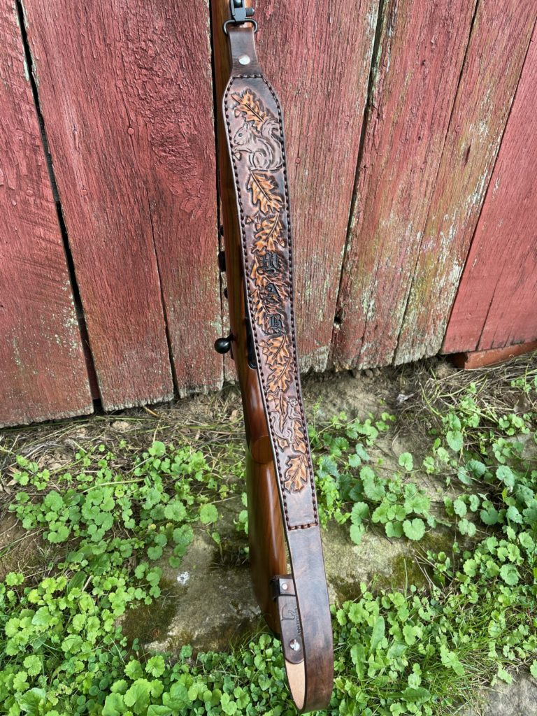 custom leather gun sling with squirrels, western floral design and old english font initials