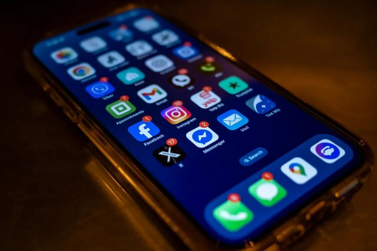 Smartphone displaying travel apps and mobile data notifications for international eSIM use