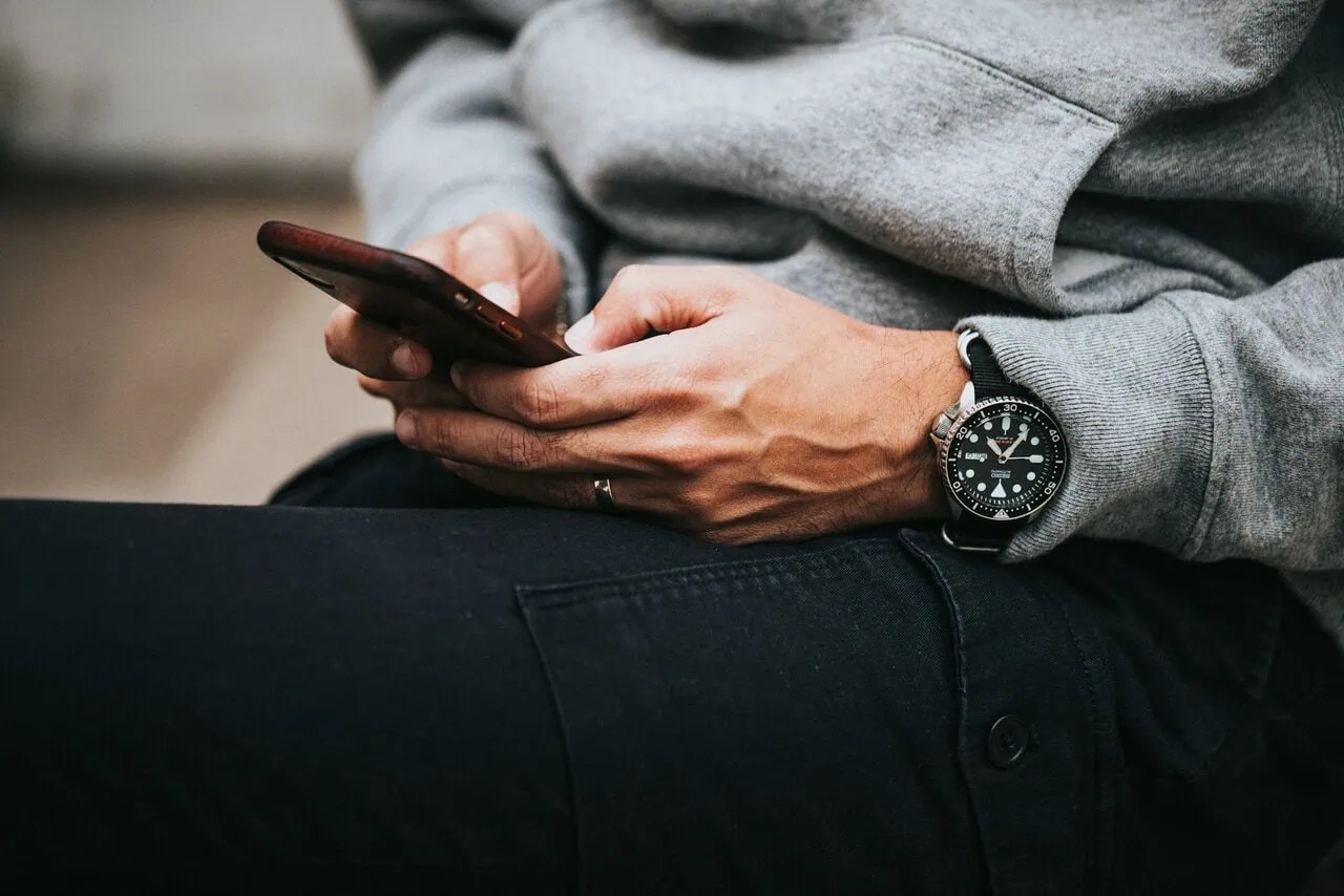 Traveller using a smartphone while comparing travel eSIM plans and mobile data options