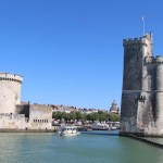The medieval Tour Saint-Nicolas and Tour de la Chaรฎne guarding the entrance to La Rochelle's Old Port, France.