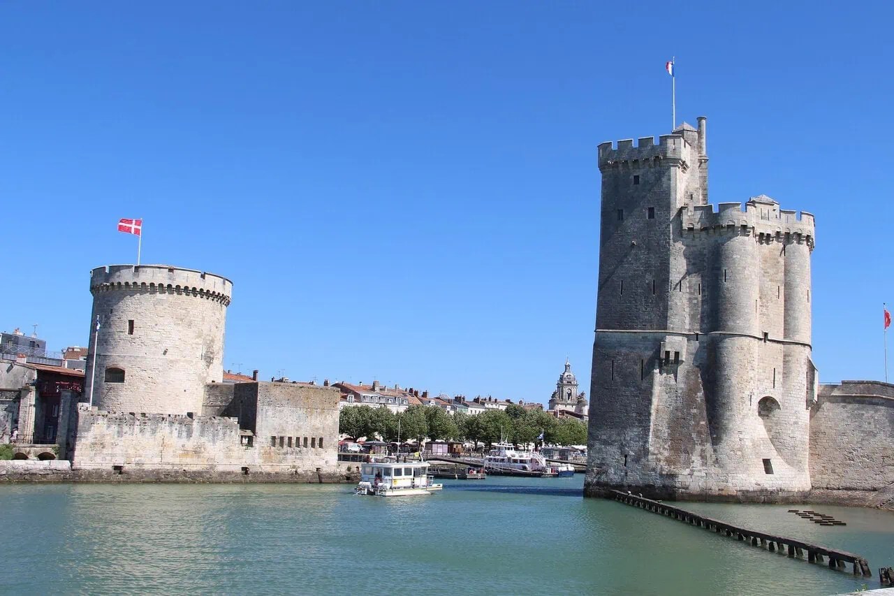 The medieval Tour Saint-Nicolas and Tour de la Chaîne guarding the entrance to La Rochelle's Old Port, France.