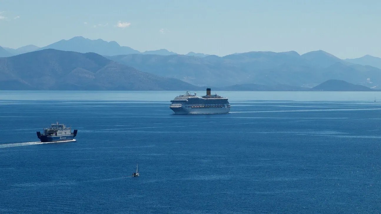 Passenger ferry and cruise ship sailing in the Ionian Sea near Corfu.