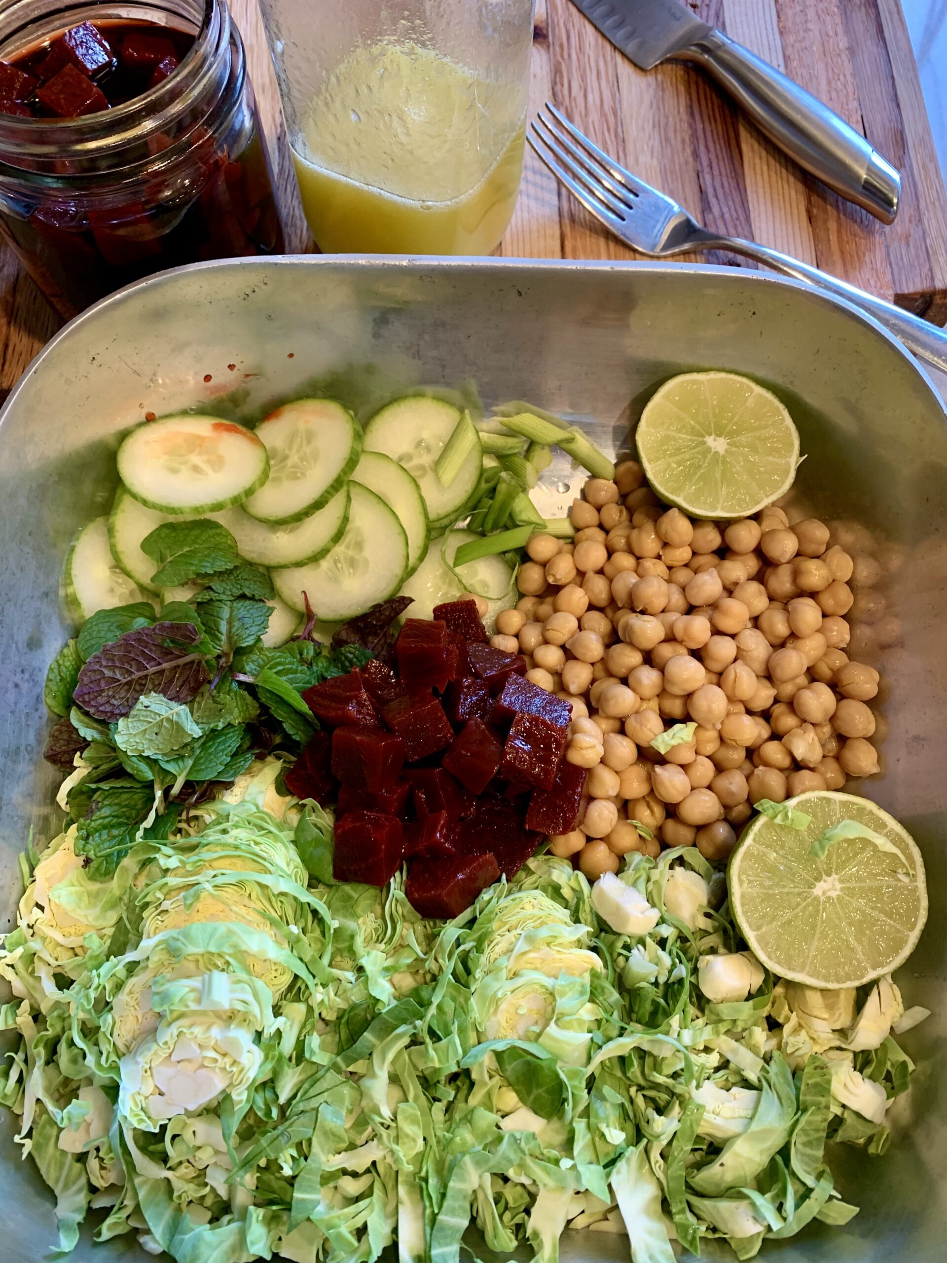 bowl with ingredients separated, Brussel sprouts, cucumbers chickpeas, pickled beets.