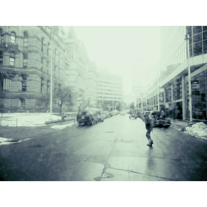 It was a clear day, but this filter determines otherwise, as this pedestrian treks across Queen St W, towards Bay St in Toronto. Photo by: Leviana Coccia.