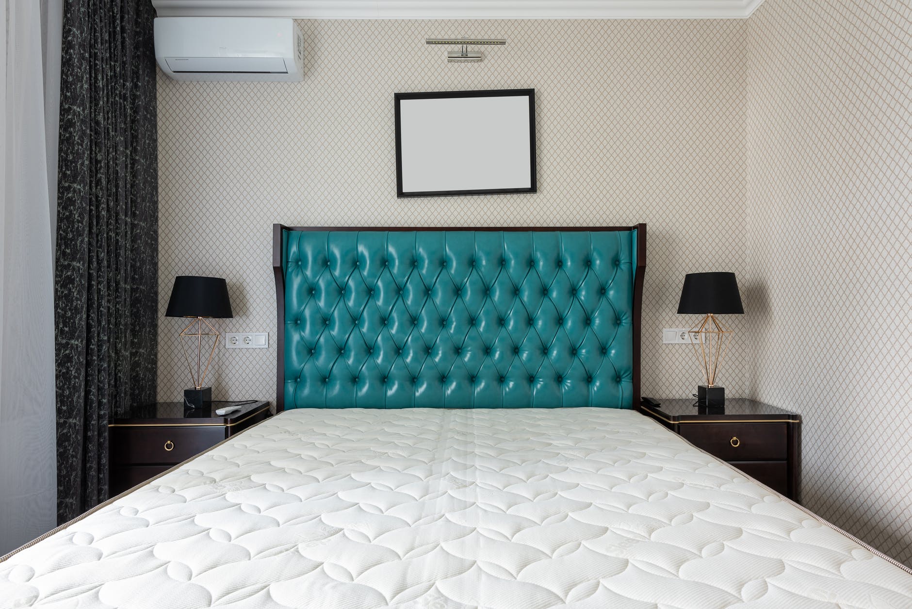 contemporary bedroom interior with bed under empty panel at home