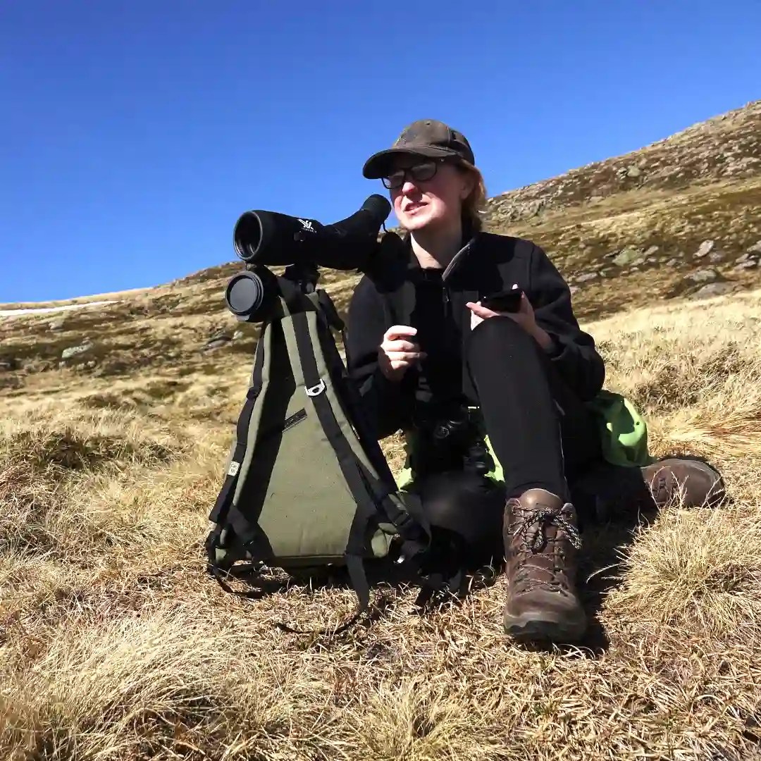 woman birdwatching during a wildlife tour from aviemore