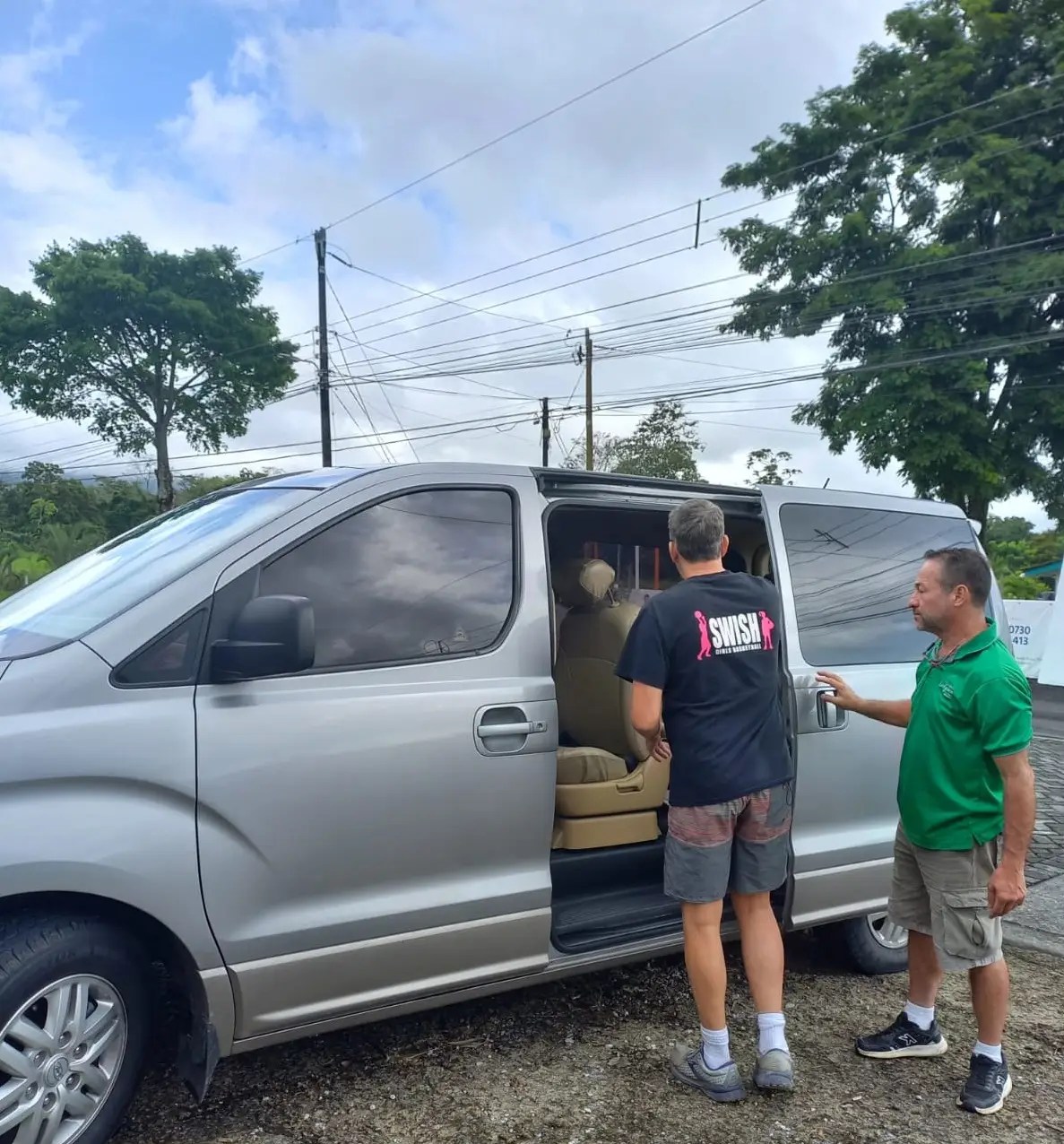 Arenal Shuttle Service van parked outside a hotel in La Fortuna.
