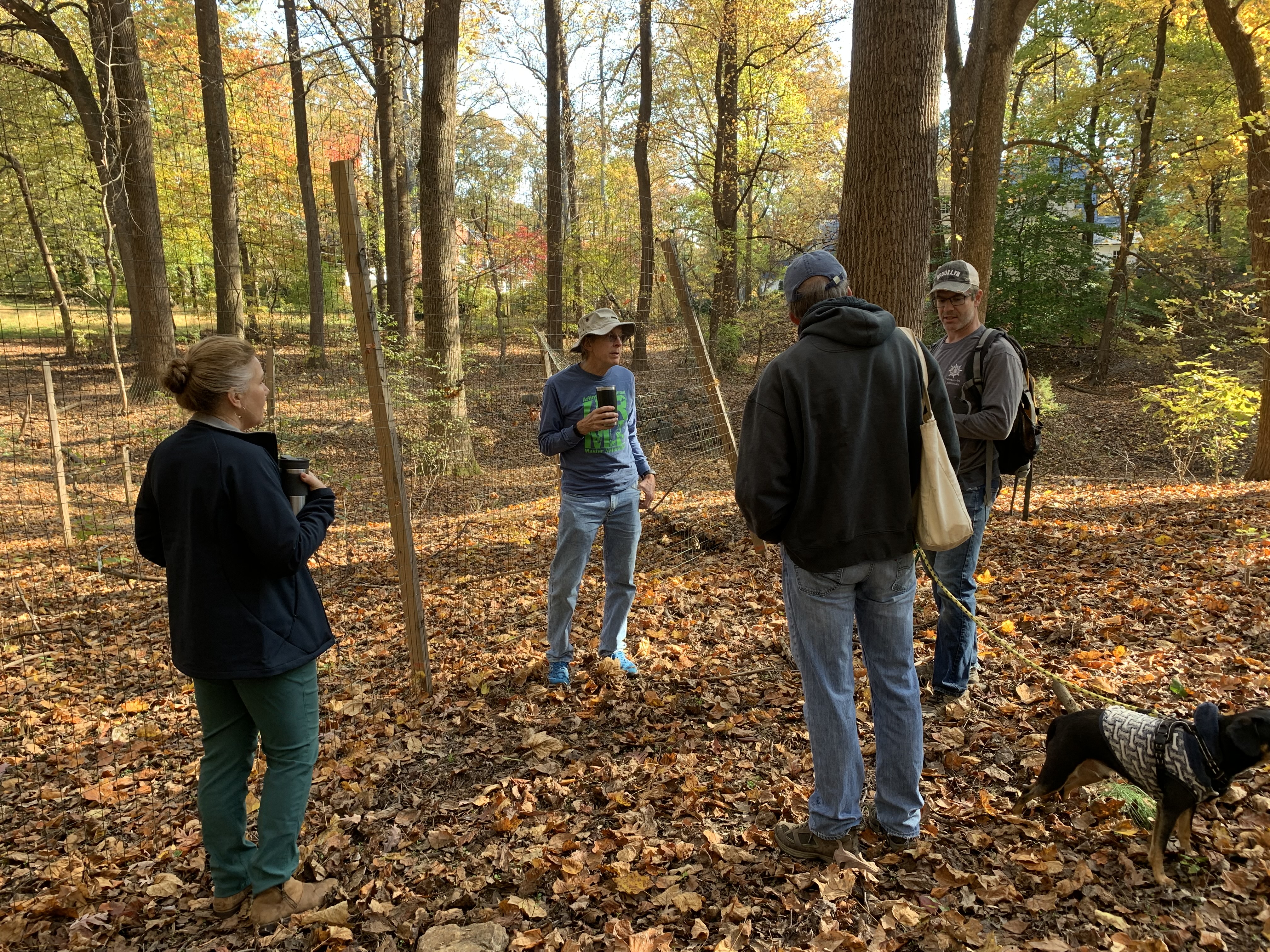 Photo of ARMN volunteers standing in front of a deer exclosure