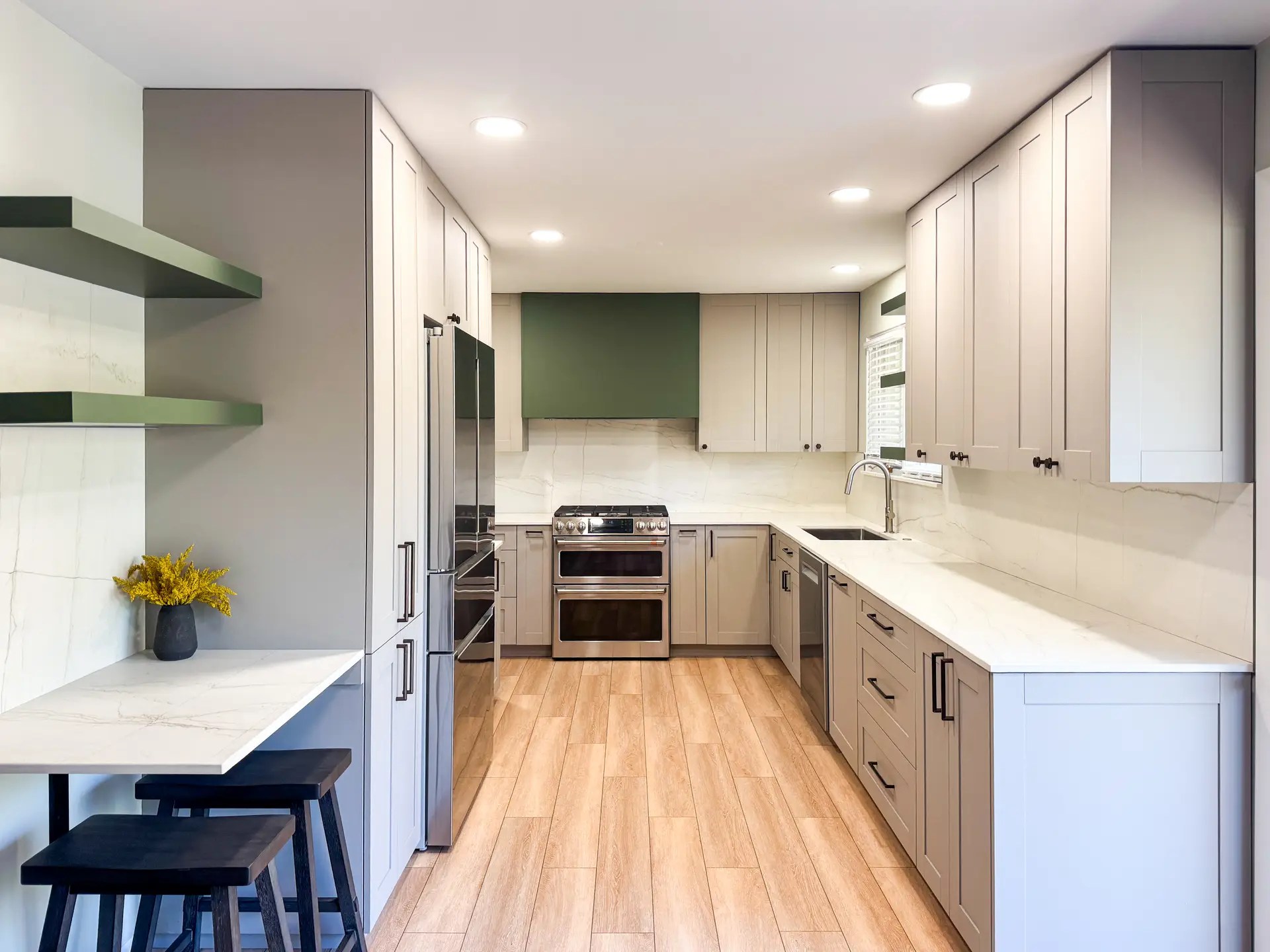 Italian Olive Galley Kitchen with greige European full-overlay cabinets, olive-green accents, porcelain countertops, full-height porcelain backsplash, stainless appliances, and Briarhaven LVP flooring.