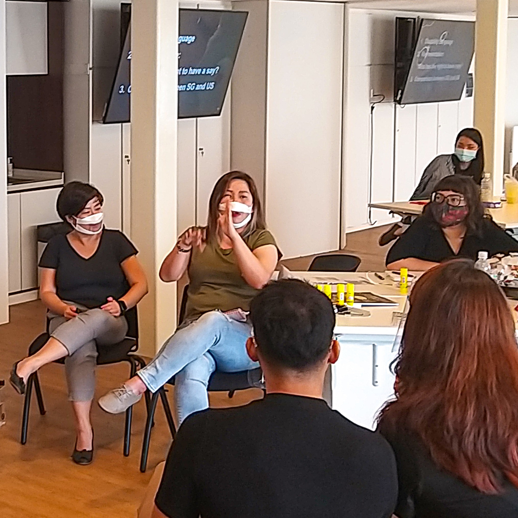This image features a Deaf participant using Singapore Sign Language to communicate her point about accessibility in the arts ecosystem.