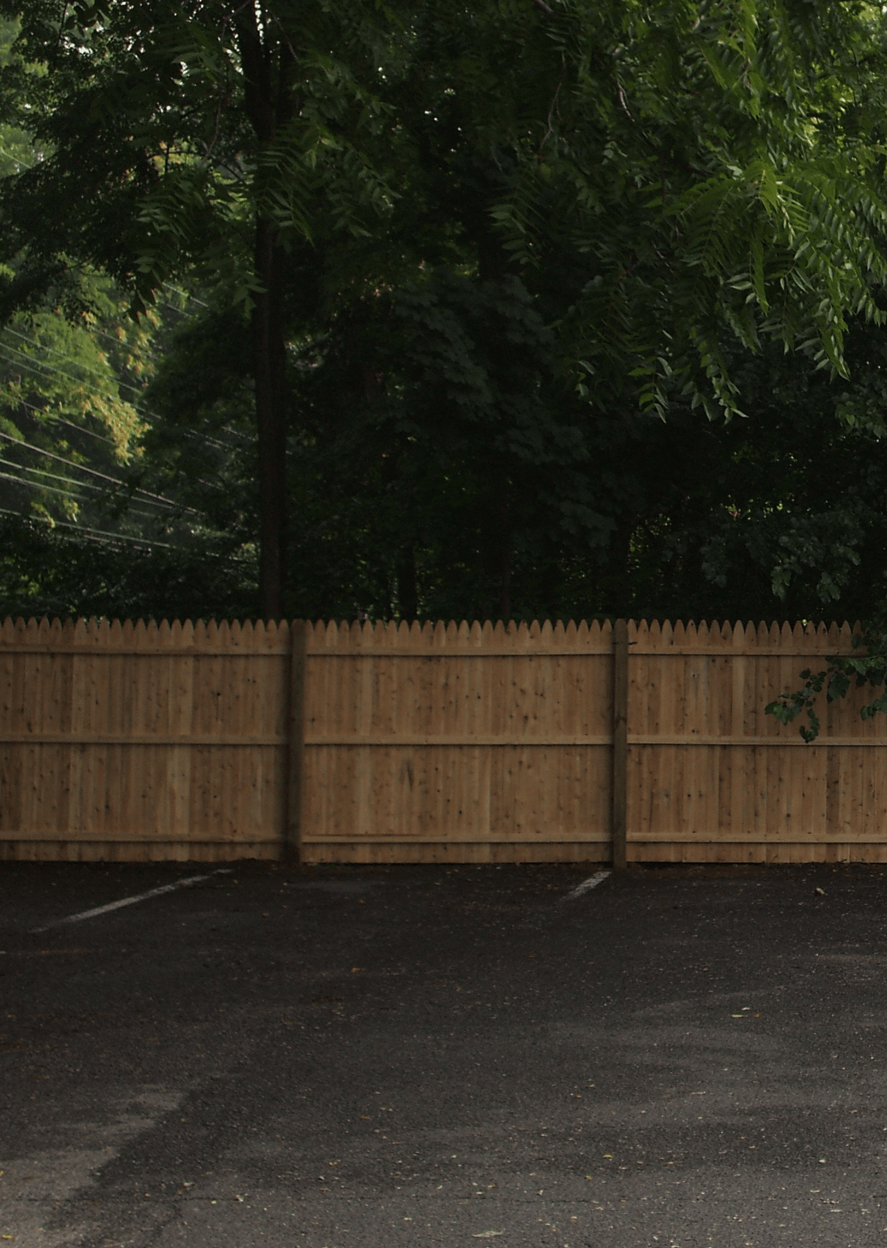 Solid wood fence in a commercial parking lot
