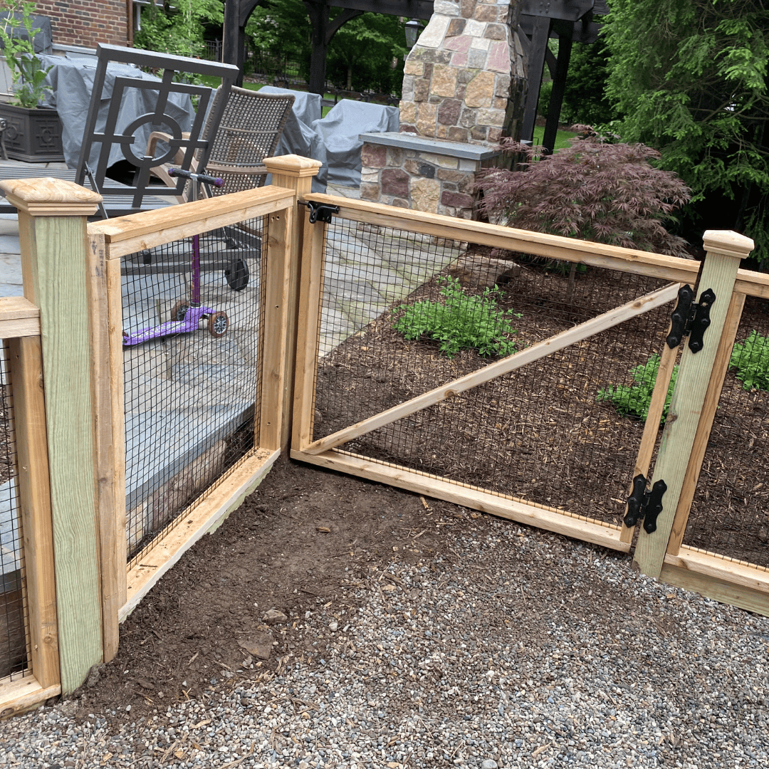 Close up of one panel of wood and wire garden fencing and gate