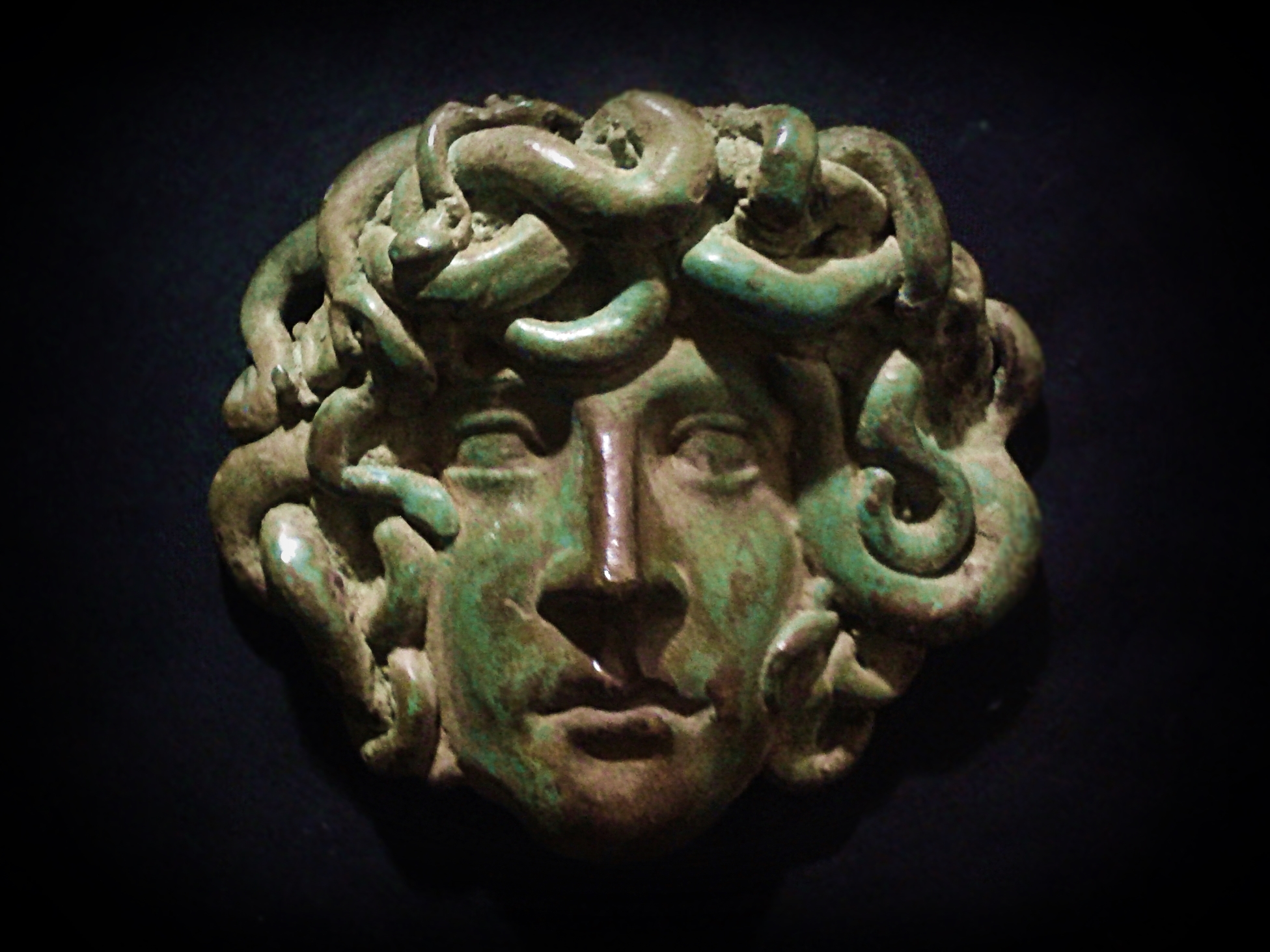 Rennaissance sculpture medallion with the representation of Medusa. Cast Bronze with chemical patina.