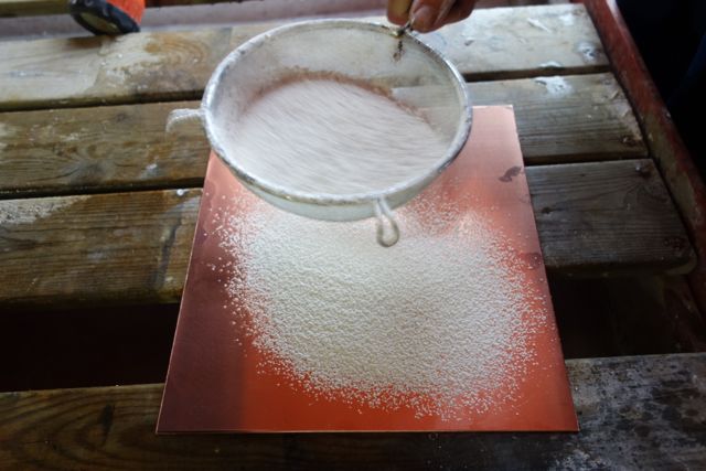 degreasing the plate using calcium carbonate