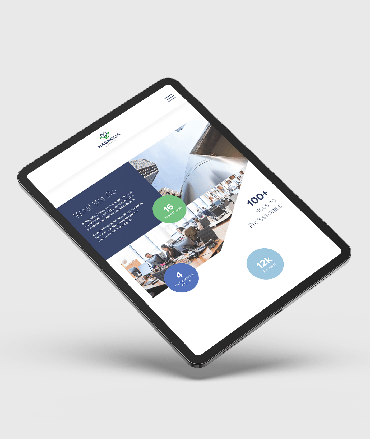 A web design for a real estate company displayed on a tablet screen.