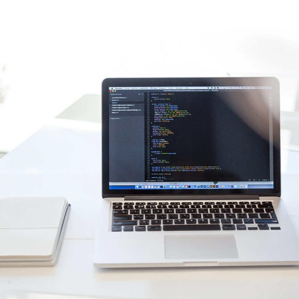 Laptop displaying code language on screen.