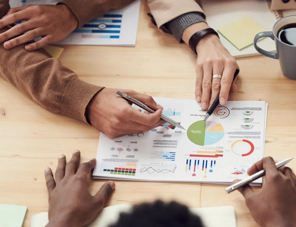 Company team analyzing metrics, data, and infographics for branding research.