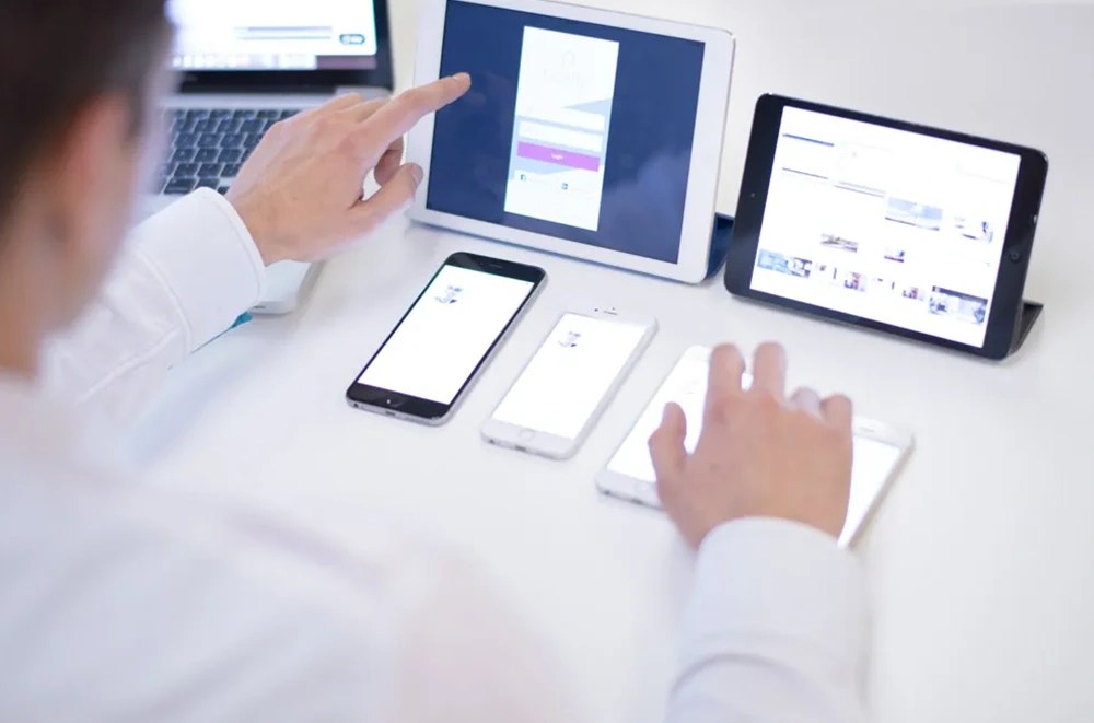 A designer conduction user testing across digital devices.