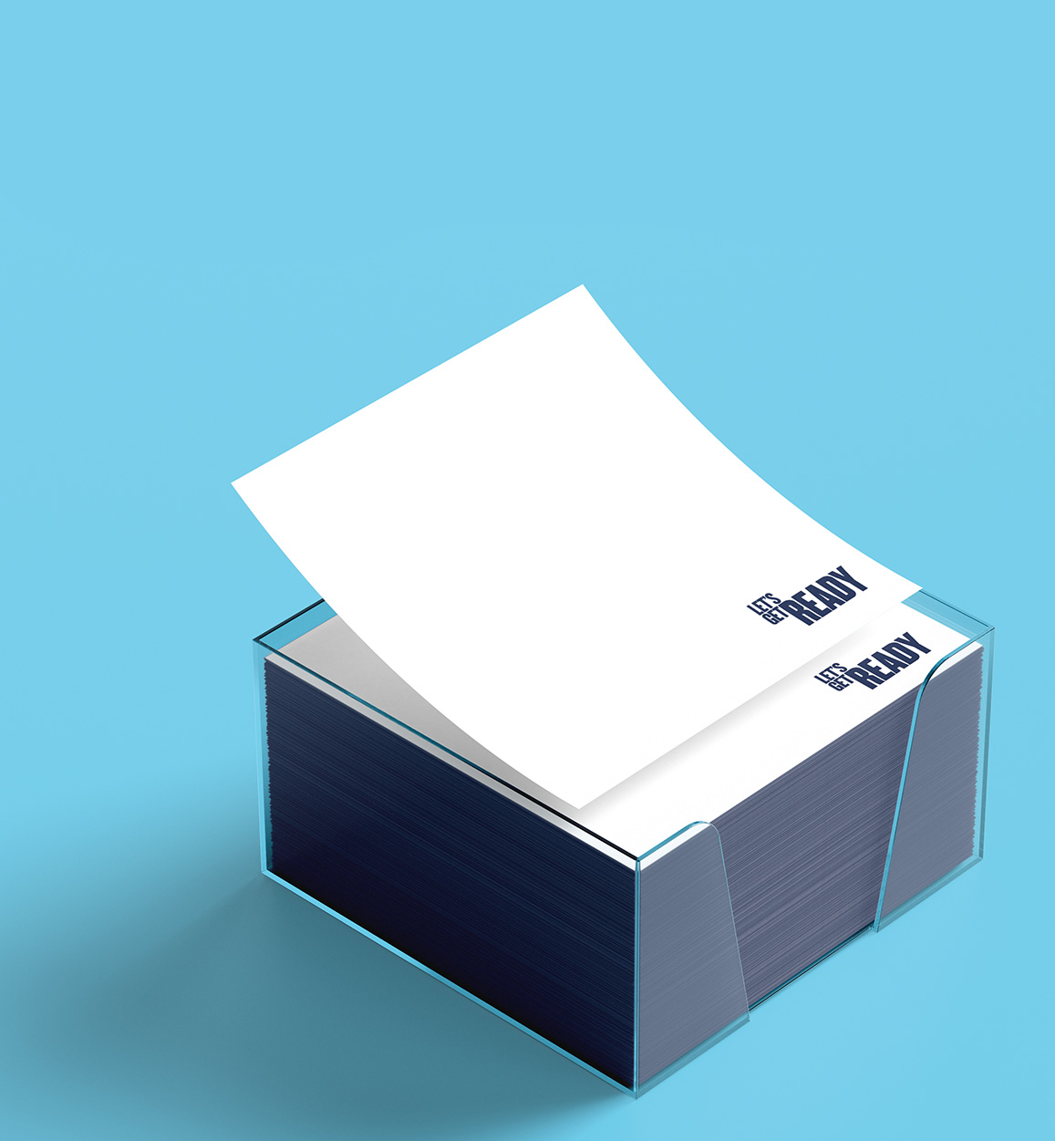 Clear acrylic sticky note holder with white notes, top sheet branded “Let’s Get Ready,” on a light blue background.