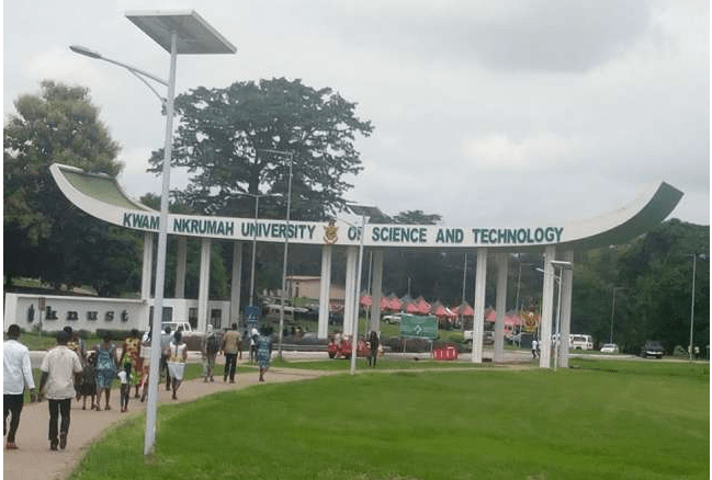 Students at the entrance to the Kwame Nkrumah University of Science and Technology (KNUST)