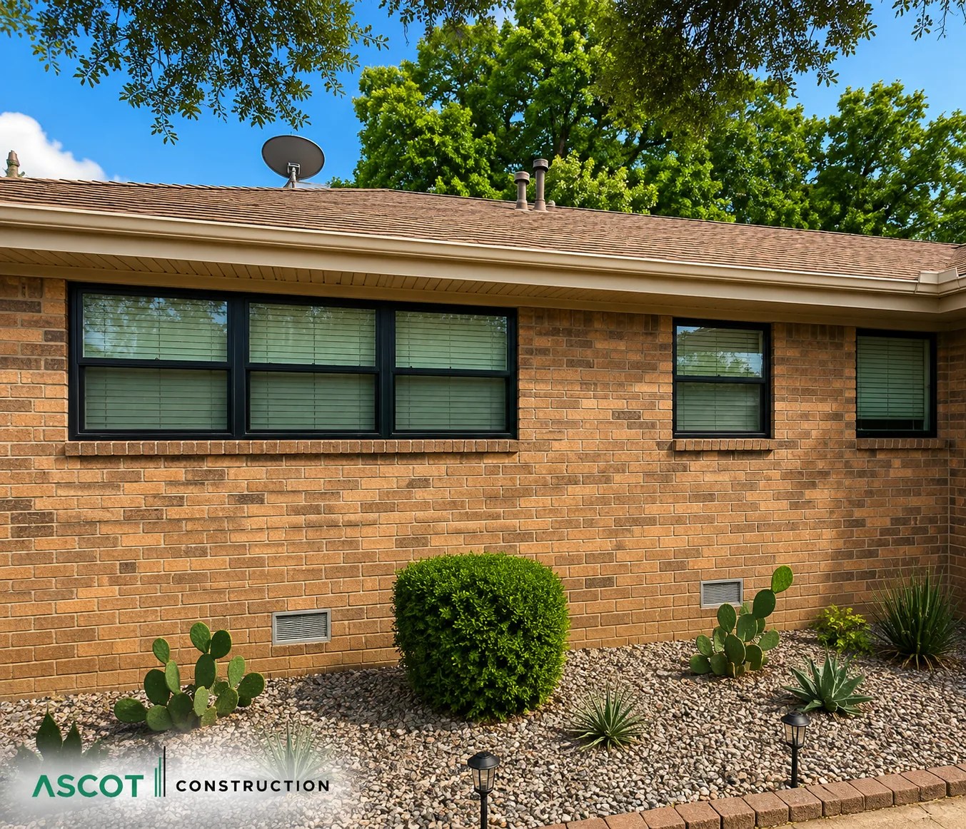Brick home exterior with updated windows, shrubs and refreshed landscaping