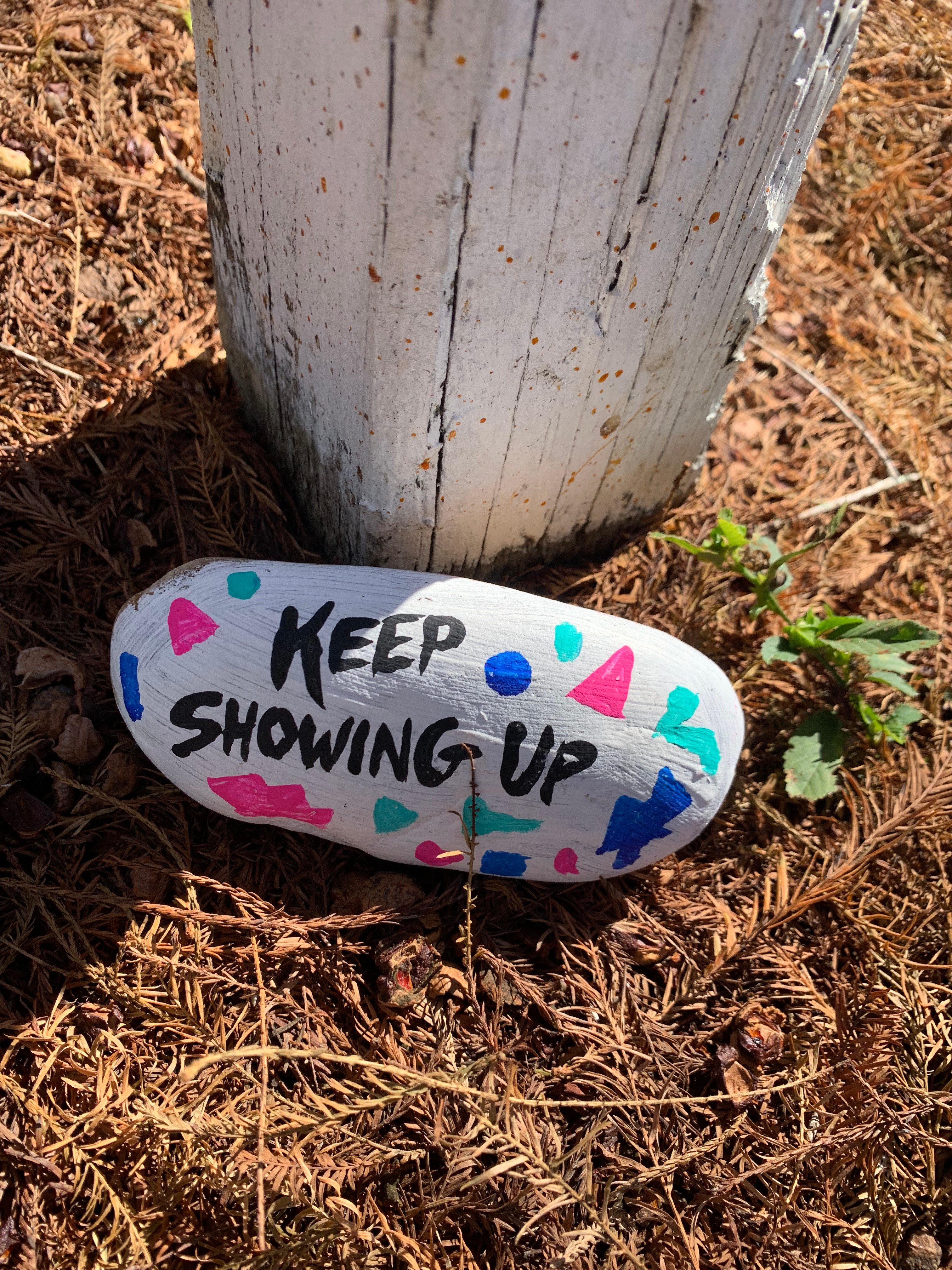 Painted Rock with generosity quote: "Keep Showing Up"