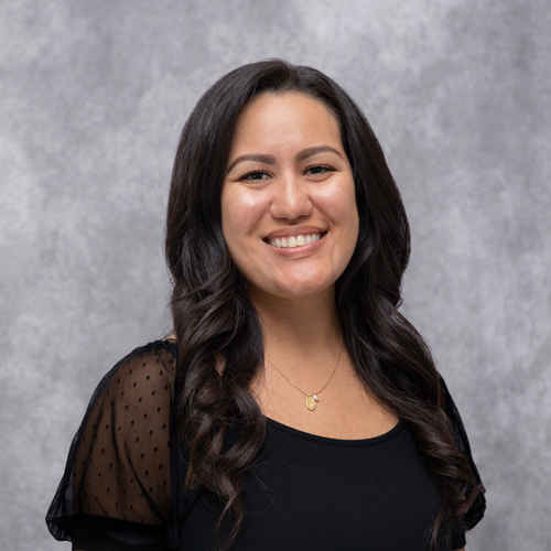 Portrait of Andrea Garcia in front of grey backdrop