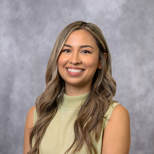 Portrait of Nicolette Mendez in front of grey backdrop