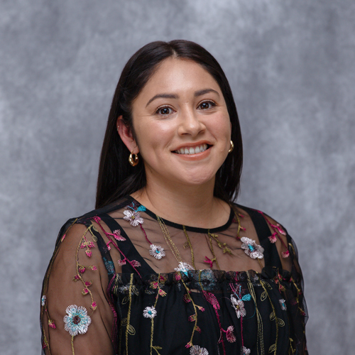 Portrait of Alejandra Gomez in front of grey backdrop