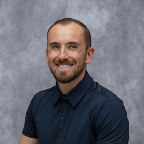 Portrait of Jonathan Leavelle in front of grey backdrop
