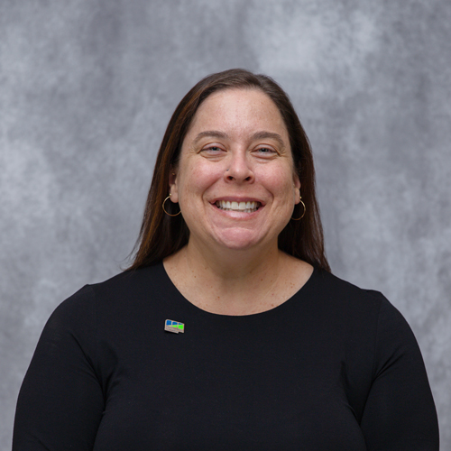 Portrait of Krista Smith in front of grey backdrop