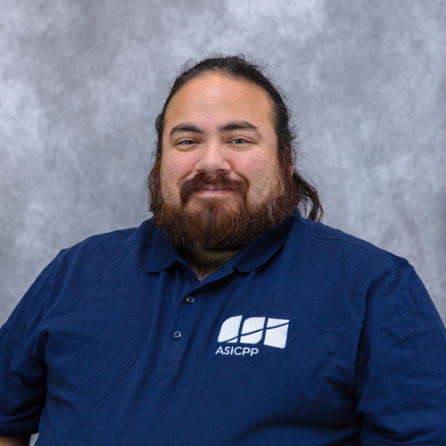 Portrait of Roman Lopez in front of grey backdrop