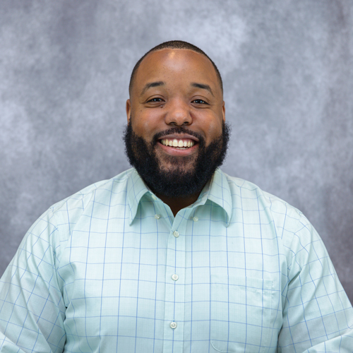 Portrait of Vic Martin in front of grey backdrop