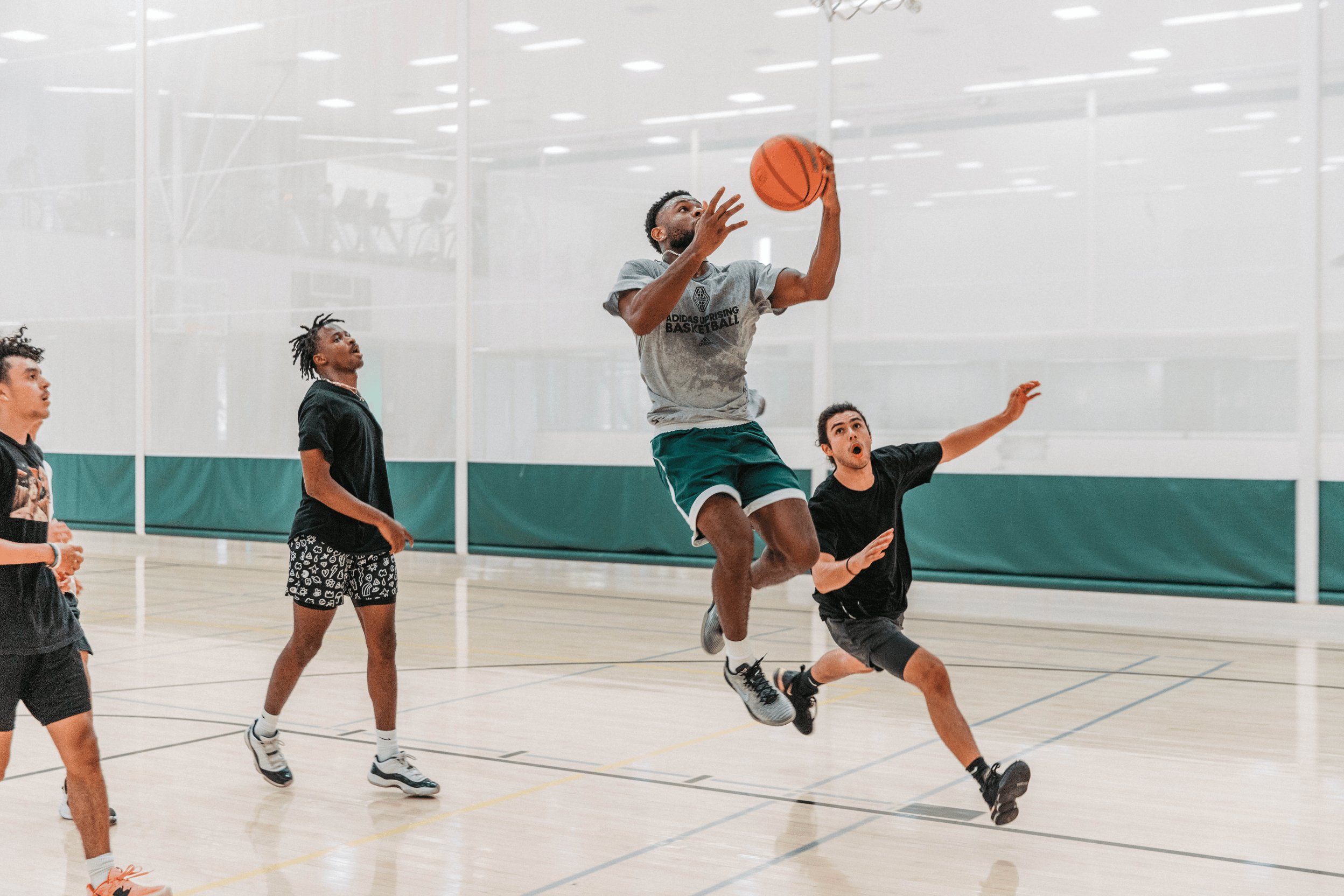 three men playing basketball