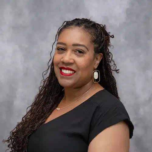 Portrait of Danisha Lawrence in front of grey backdrop