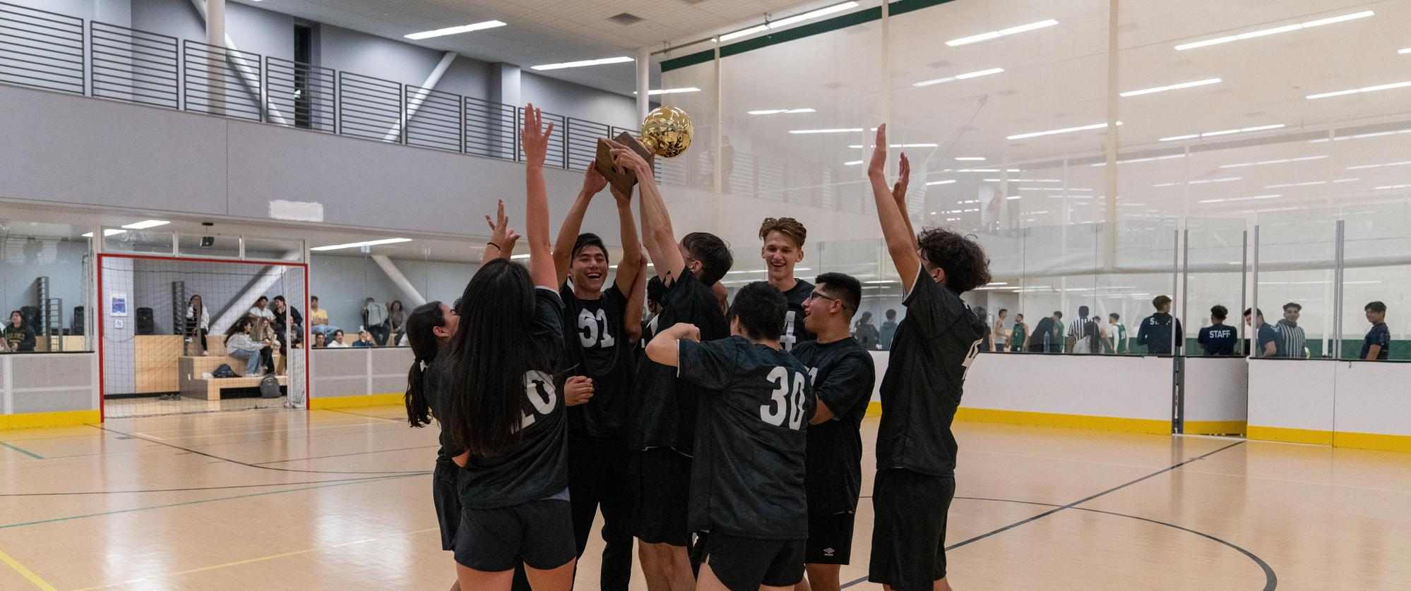 Soccer champions cheering in a huddle