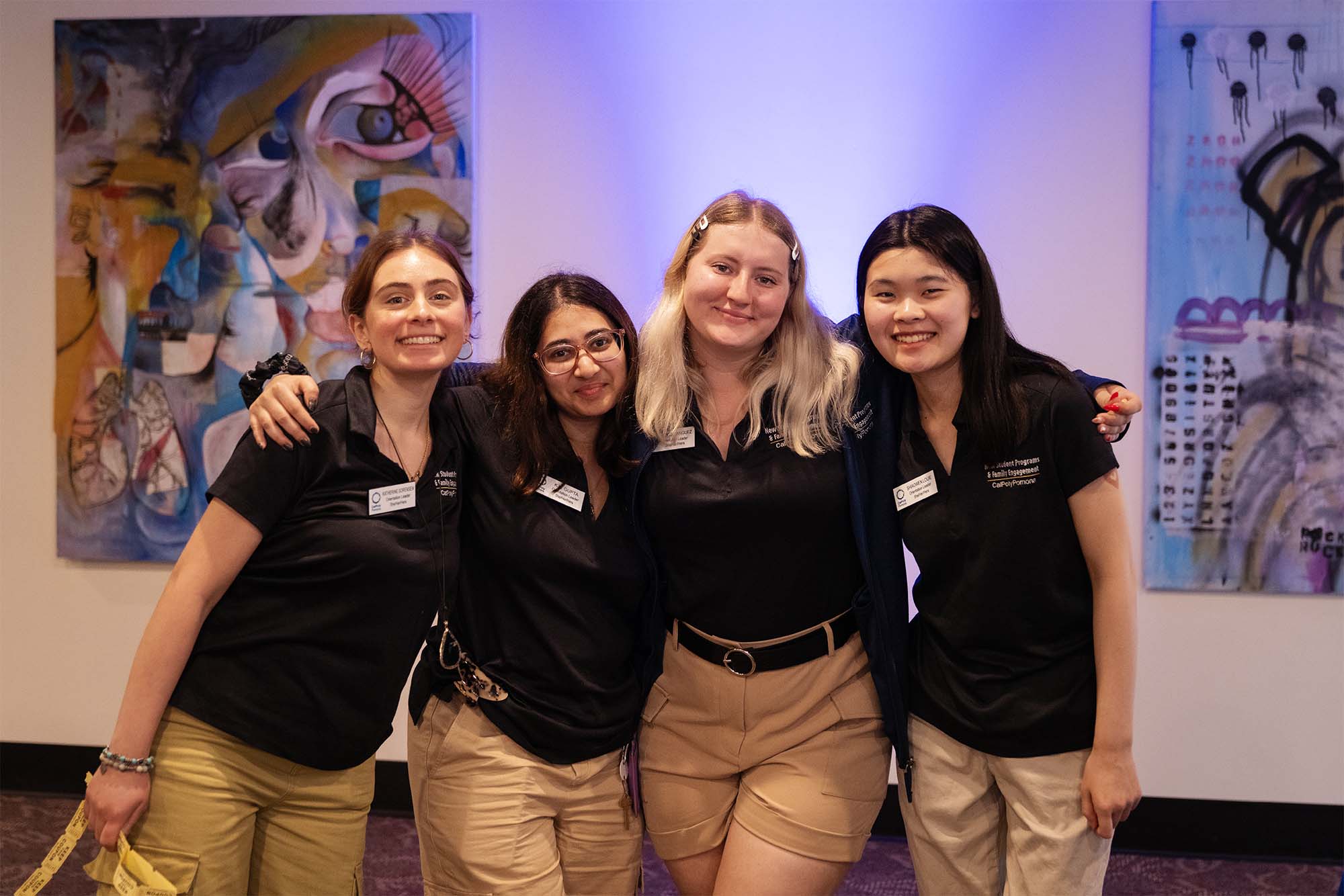 Four Orientation Leaders posing together for the camera