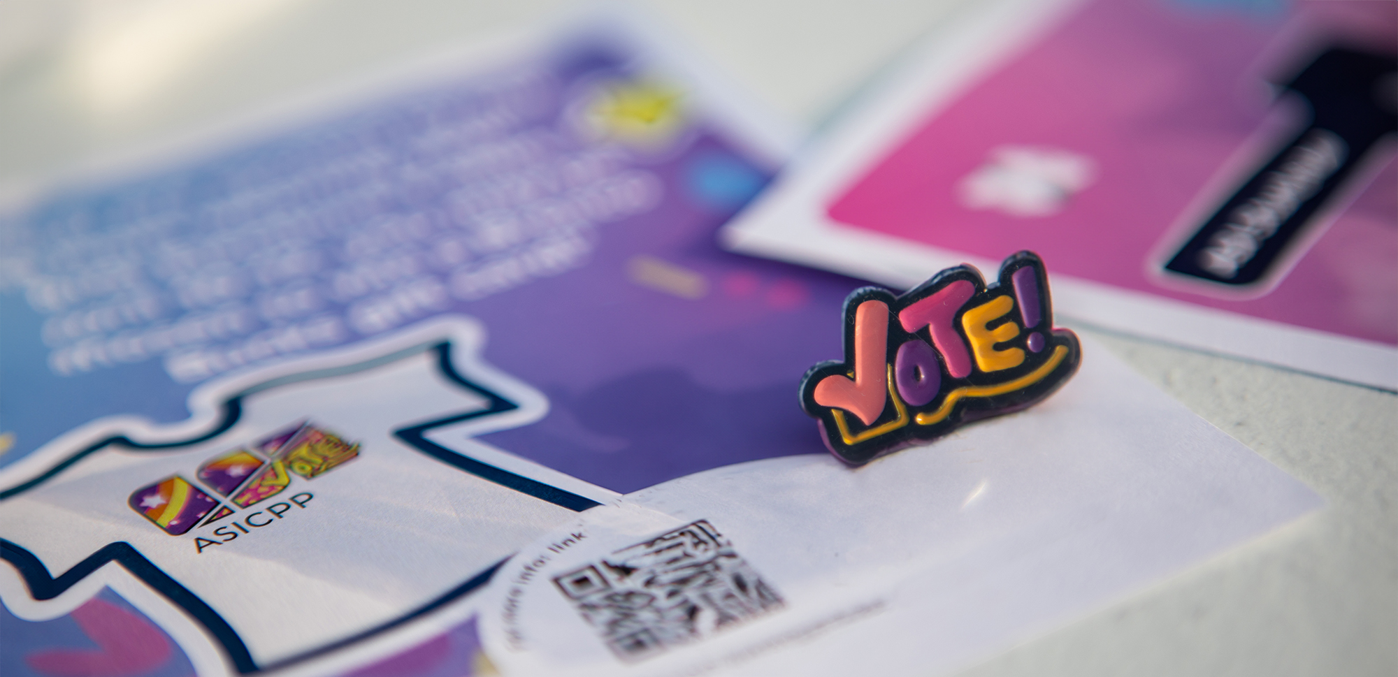 Vote pin and Elections fliers on a table