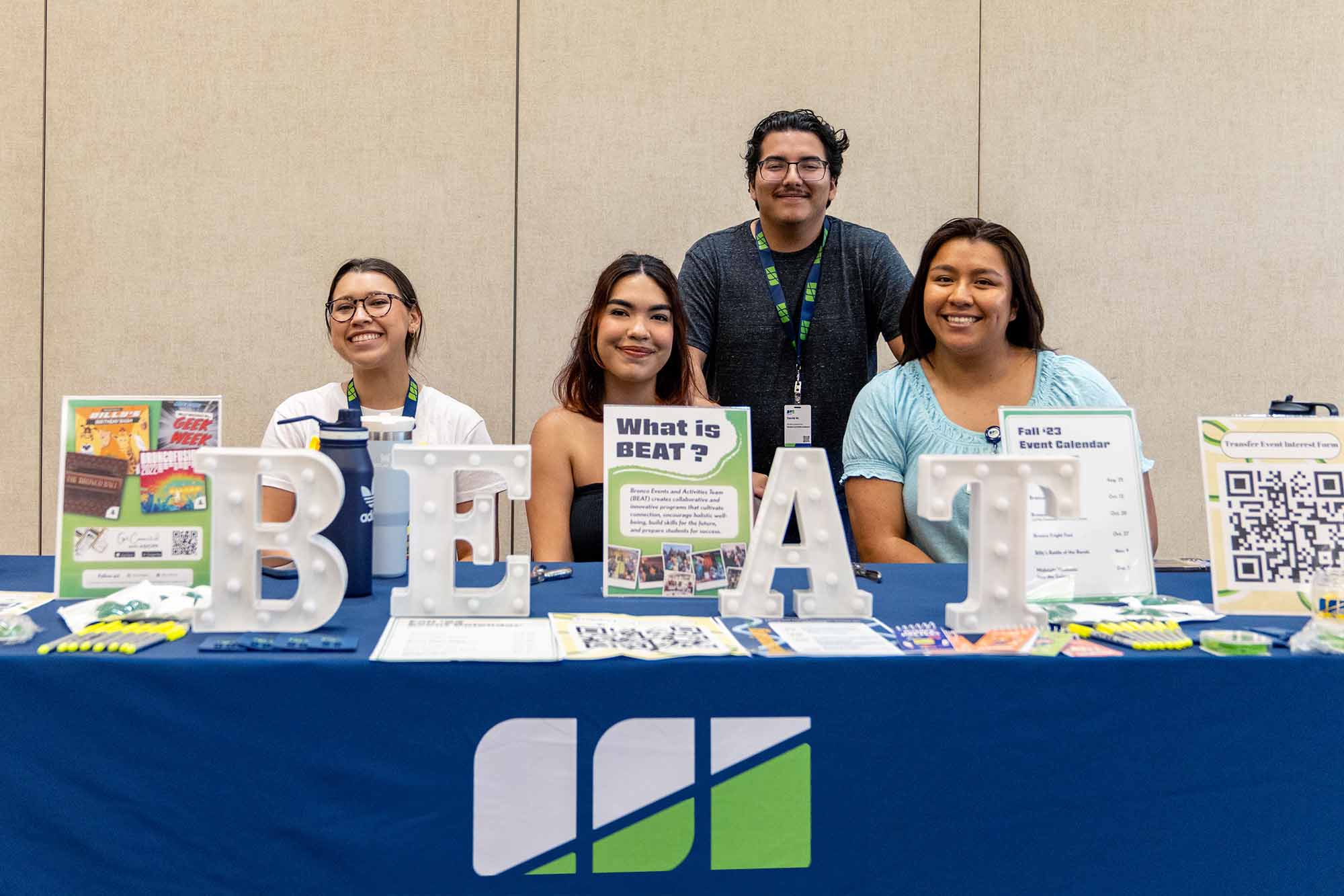 BEAT staff sitting at a table with advertising displays