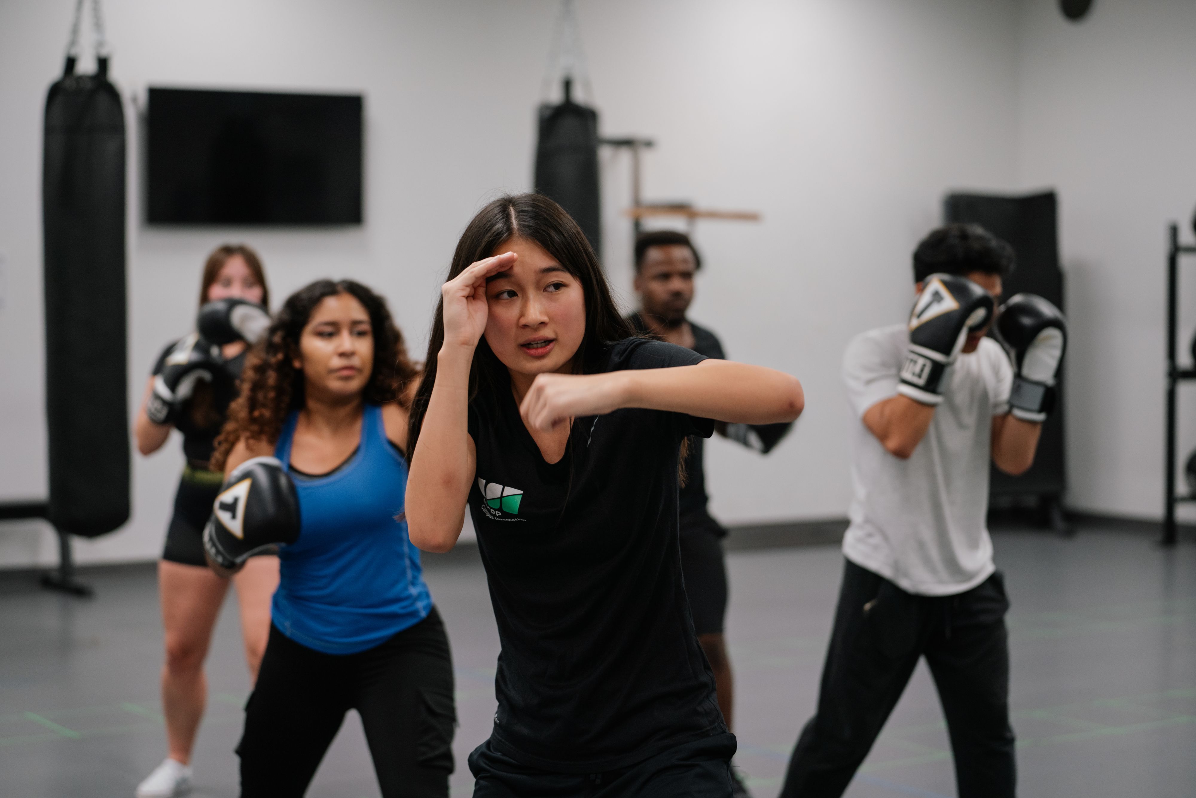 An instructor teaching students a martial art technique