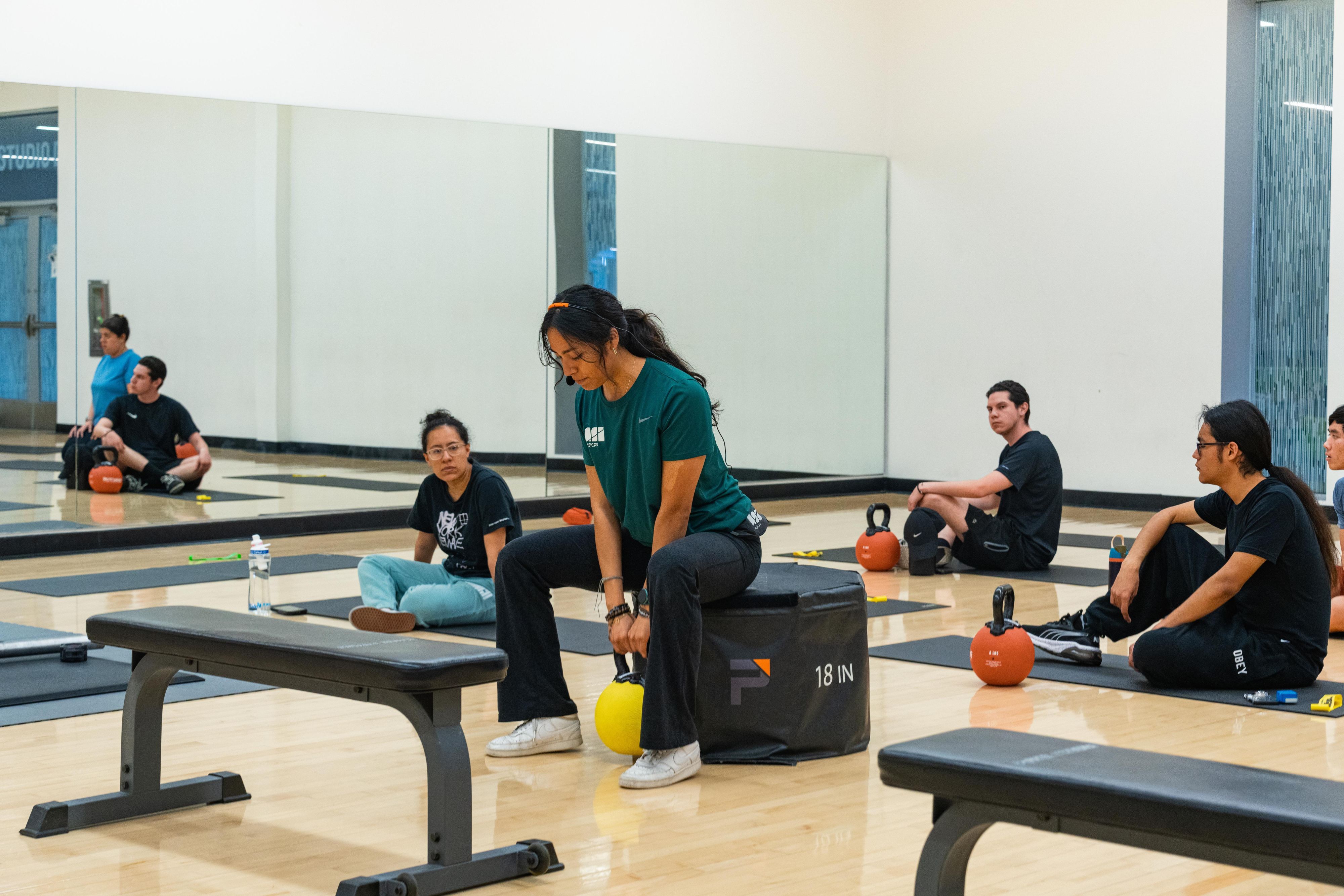 Fitness Instructor teaching class how to correctly deadlift