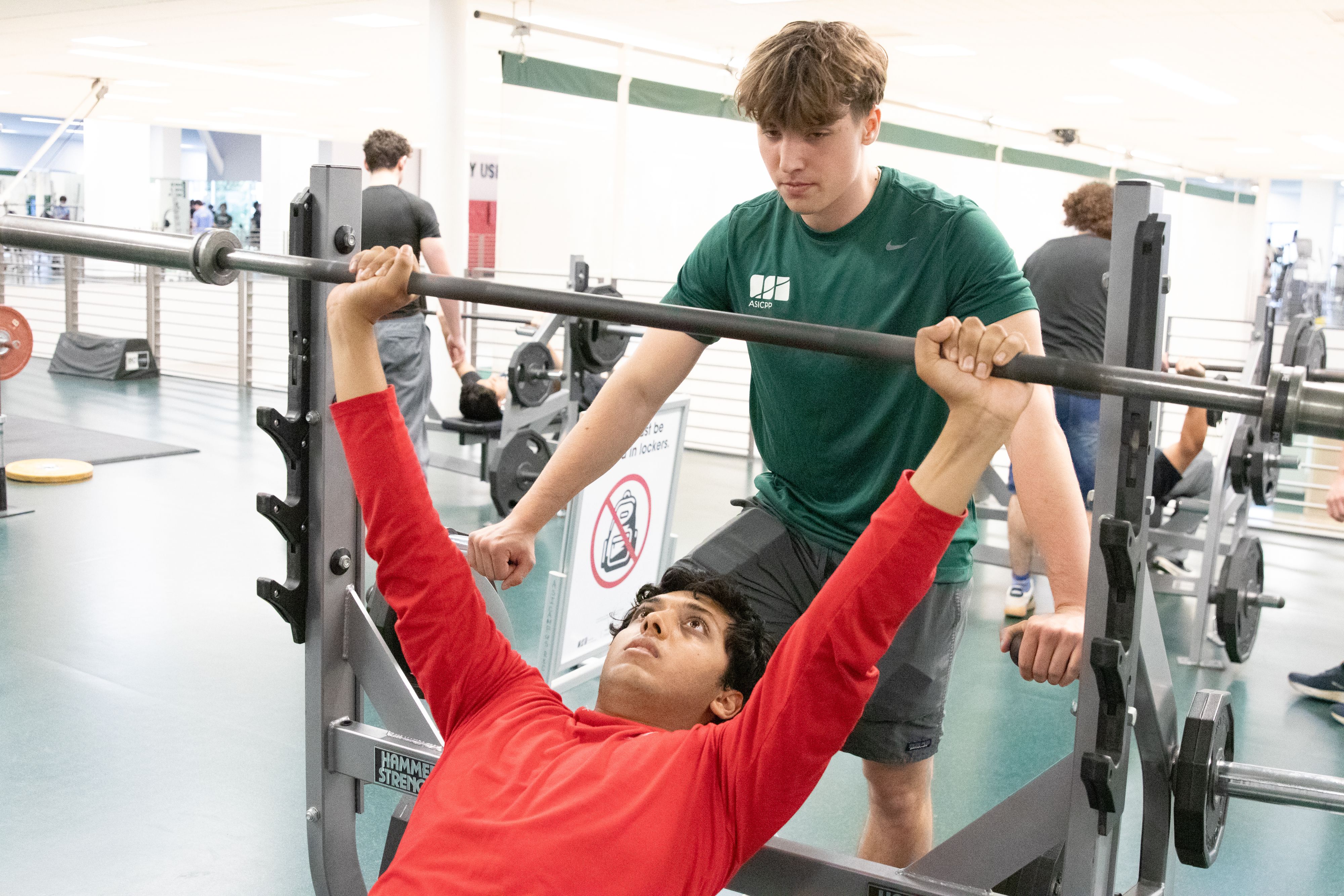 Personal trainer assisting a student with balance exercises