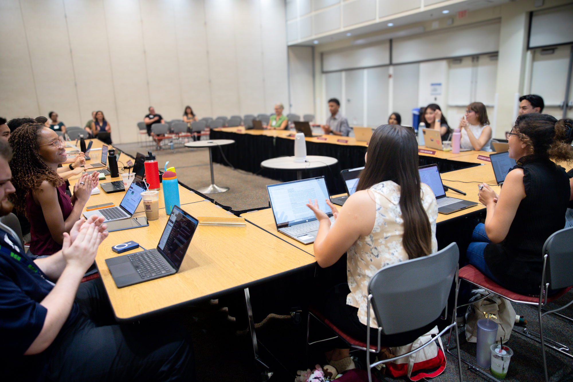 Student leaders sitting at tables conducting a meeting