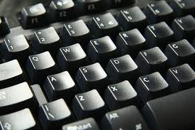 A close-up view of a computer keyboard shows black keys with white letters and numbers, perfect for snagging deals on Cyber Monday.