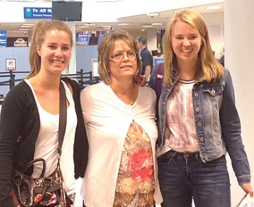 Adele Justice, center, welcomes the foreign exchange students to America at the Salt Lake International Airport, Laure Anne Bya and Lili Zoe Peetz.