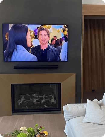 Professional TV installation above fireplace by Associated Integrated Systems